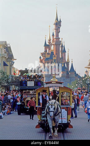 The Castle with Main Street shops, rides and people during daytime at Euro Disneyland at Euro Disney Resort outside Paris Stock Photo