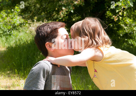 Little girl kissing a boy Stock Photo