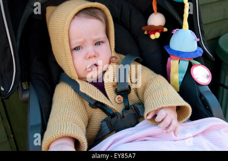 Portrait of baby girl sitting in her pram Stock Photo