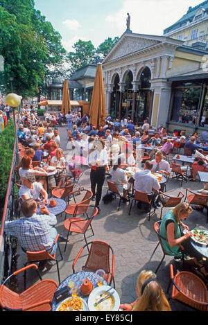 Summer tourists and activities around outdoor sidewalk restaurants near South Harbor in Helsinki, Finland Stock Photo