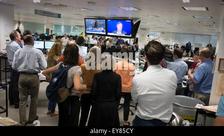 Financial Times newsroom editorial staff and journalists watch the news during the announcement of the takeover of the FT newspaper and website by Nikkei Stock Photo