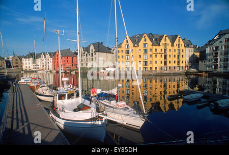 Apartments and boats along canal at sunrise in Ålesund, Norway Stock Photo