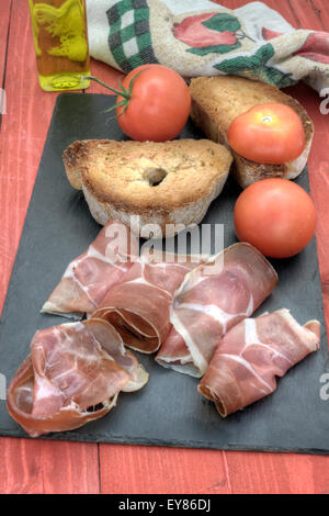 a vertical view of a traditional mediterranean dish, pan tumaca with spanish ham Stock Photo