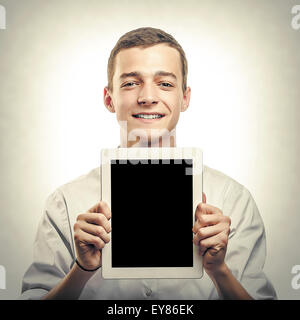 Young man showing tablet pc. Stock Photo