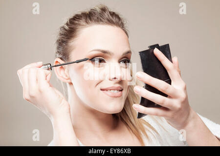 Young woman applying mascara Stock Photo
