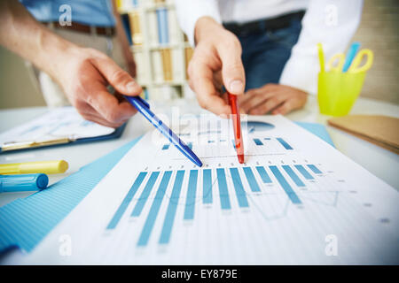 Two colleagues discussing business document at meeting Stock Photo