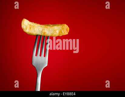 Chip on silver Fork with a red background Stock Photo