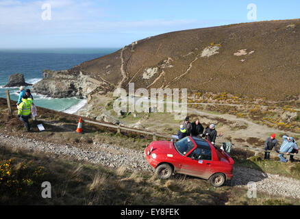 A red Suzuki X-90 car takes part in a hill climb event at a clifftop location. Stock Photo