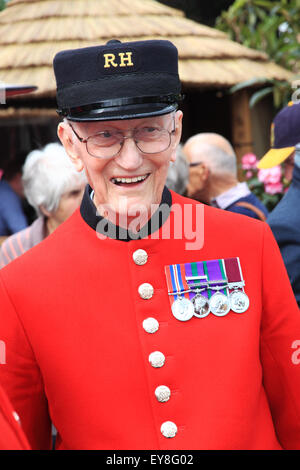 A Chelsea Pensioner dressed in his red coat wearing a Royal Hospital Cap and displaying his medals. Stock Photo