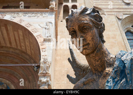 VERONA, ITALY - JULY 13: Bronze statue The Blue Angel of Acceptance, or Hospitality, by Albano Poli, in front of Duomo di Verona Stock Photo