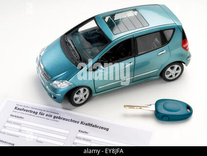 Car with key and purchase agreement for a used vehicle.