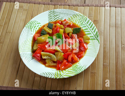 Pisto -  Spanish dish . made of tomatoes, onions, eggplant or courgettes, green and red peppers and olive oil Stock Photo