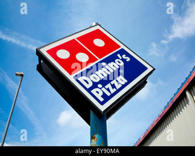 A logo sign outside of a Domino's Pizza restaurant location in ...