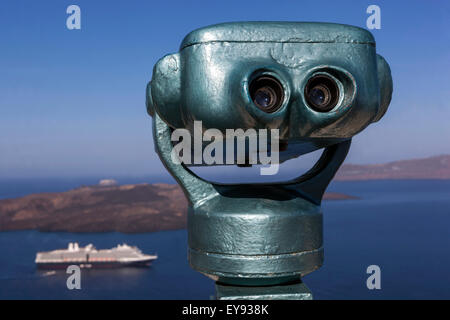 Coin operated binocular above the sea. View from terrace to the caldera with a boat, Santorini, Thira, Cyclades Islands, Greece, Europe Stock Photo