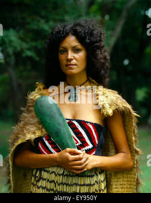 A New Zealand Maori woman in a kapa haka (traditional dance) costume ...