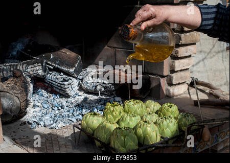 Artichokes with olive oil soon to be cooked;  Tarragona, Benissanet, Spain Stock Photo