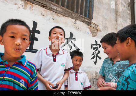 Young boys playing beside their school in a small village near Wuyuan; Jiangxi province, China Stock Photo