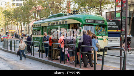 People line up to board a Heritage Streetcar on Market Street , San Francisco,one of several different Vintage streetcars to be found in San Francisco Stock Photo