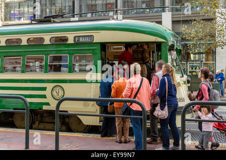 People line up to board a Heritage Streetcar on Market Street , San Francisco, one of several different Vintage streetcars running on Market St Stock Photo