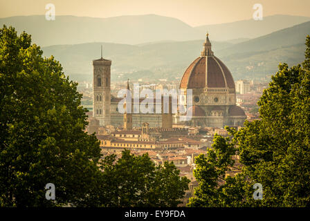 The south façade of Florence Cathedral glimpsed through the trees of San Miniato al Monte. Florence. Italy. Stock Photo