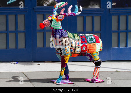 Decorated wire-framed deer, 'Yarn Bombed' & covered with crocheted woollen squares using of various colours of wool. Blackpool, UK Stock Photo