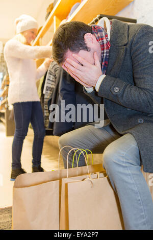 View of a Young casual man waiting while his wife's shopping Stock Photo