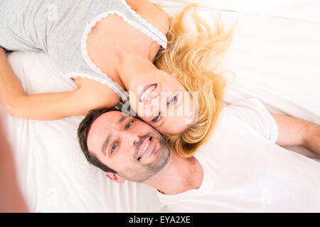 View of a Young attracttive couple taking selfies in bed Stock Photo