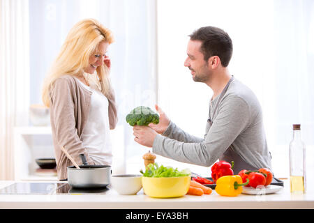 View of a Young attractive couple having fun in the kitchen Stock Photo
