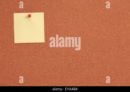 Cork board with notes and red pins Stock Photo