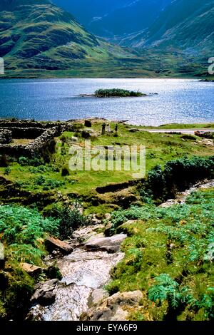 Doo Lough, Co Mayo, Ireland; Tourists By An Old Cottage Ruin Stock Photo