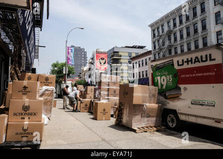 Delivery truck, workmen unloading merchandize, boxes on sidewalk, Bowery street, Chinatown, New York City, Manhattan, USA. Stock Photo