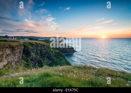 Sunset from the cliffs at Port Gaverne in Cornwall, looking out to Port Isaac Stock Photo