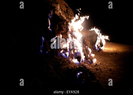 Natural gas erupting from the earth and burning in Yanar Dag also called the Burning Hill on a hillside in the Absheron Peninsula near the city of Baku capital of Azerbaijan Stock Photo