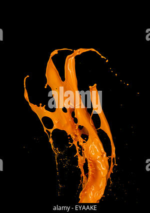 Orange paint splash on black background Stock Photo