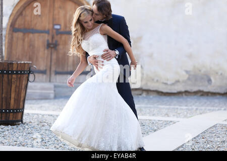 Newlywed couple dancing outdoors, expressing happiness and lots of joy. Stock Photo