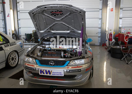 Silverstone, UK,25th July 2015, Opel engine being worked on in the pitts at Silverstone Classic 2015 The worlds biggest classic motor racing festiva Credit: Keith Larby/17�Թ����� Live News Stock Photo