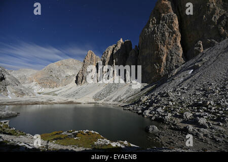 Moonlight on lake Antermoia. Night mountain landscape. The Catinaccio massif (Rosengarten). The Dolomites of Fassa valley. Italy. Europe. Stock Photo