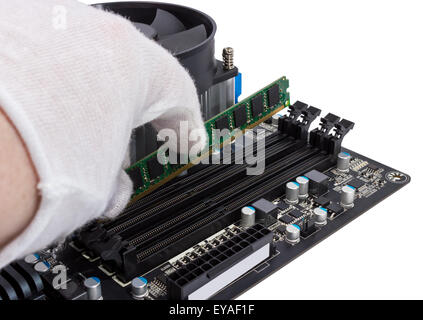 Installing memory module in DIMM slot on modern PC computer motherboard Stock Photo