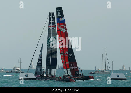 Portsmouth, UK. 25th July, 2015. Competing teams participate (L-R)Britain's Land Rover BAR (Ben Ainslie Racing) and Emirates New Zealand compete in the first official race of the 35th America's Cup World Series Races at Portsmouth in Hampshire, UK Saturday July 25, 2015. The 2015 Portsmouth racing of the Louis Vuitton America's Cup World Series counts towards the qualifiers and playoffs which determine the challenger to compete against the title holders Oracle Team USA in 2017. Credit:  Luke MacGregor/Alamy Live News Stock Photo