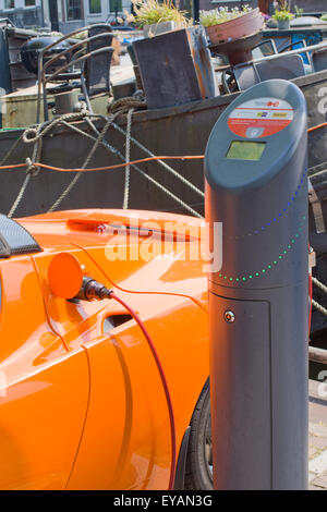 Tesla electric car charging battery at public charging point Amsterdam Holland Stock Photo