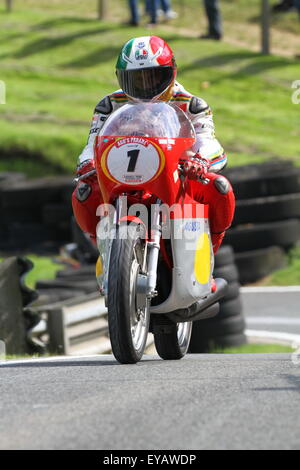 Fifteeen times world motorcycle racing champion Giacomo Agostini has joined thousands of bike racing fans from across the globe at the historic Cadwell Park motor racing circuit in Lincolnshire UK to celebrate the Cadwell Park International Classic, the world's finest gathering of historic racing motorcycles in recent history. Stock Photo