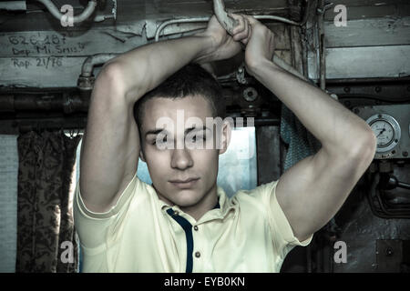 Portrait of Young Attractive Man Standing in Old Vintage Train Locomotive Car Stock Photo