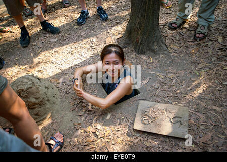 A Vietnamese woman emerging from the Cu Chi Tunnels in Vietnam Stock Photo