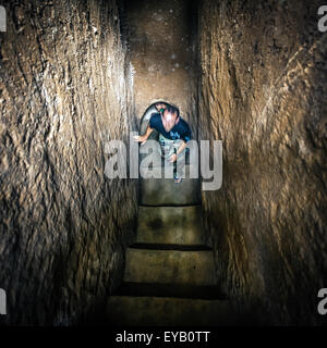 Man standing at bottom of Cu Chi tunnels, Vietnam Stock Photo