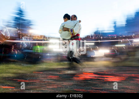 Rozhen, Bulgaria - July 18, 2015: A nestinar with a child is walking on fire during a nestinarstvo show. The fire ritual involve Stock Photo