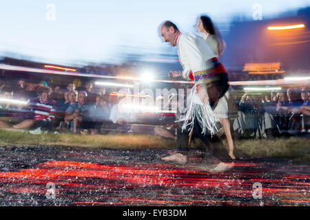 Rozhen, Bulgaria - July 18, 2015: A nestinar is walking on fire during a nestinarstvo show. The fire ritual involves a barefoot  Stock Photo