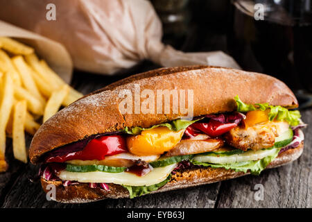 Chicken sandwich, fries and glass of soda Stock Photo