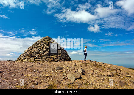 A solitary walker at the summit cairn of Dunkery Beacon (1,705ft) - the highest point of Exmoor and Somerset, England, UK Stock Photo