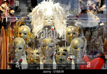 Venetian Carnival masks - mock gold - silver  feathers decorations - mystical - unreal  - window display - Venice - Italy Stock Photo