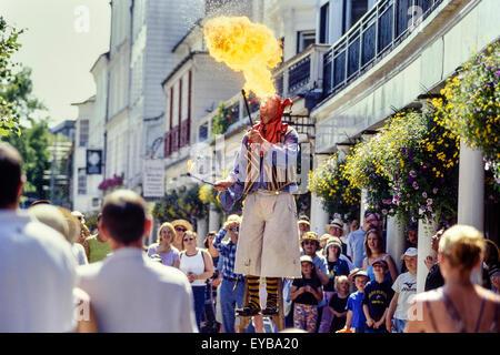 Fire breather on stilts at The Pantiles. Royal Tunbridge Wells. Kent. UK Stock Photo